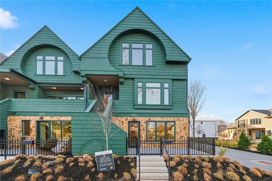 Welcome to Orchard Trailside, Bentonville’s most esteemed luxury townhome community. An urbanist’s hub in the thriving downtown scene, the property features a fresh and modern reimagining of the Craftsman Revival style. Features incredible amenities, including a whole home water filtration system, air quality scrubber, luxurious finishes, and a versatile mother-in-law suite. Enjoy smart home convenience with controlled cameras, locks, and more, making everyday living both comfortable and modern! This upscale nine-unit enclave blends solid, high-quality architectural features and natural elements with intentionally curated, sleek finishes. Living is easy here with immediate, out the-door access to the Downtown Trail and the nearby Razorback Greenway. Units feature a simple yet refined aesthetic that exudes character, warmth, functionality, and a distinct urban-meets-artisan vibe.