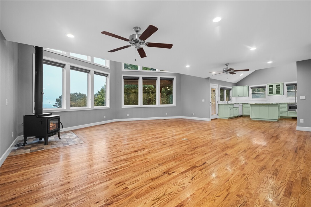 Enjoy quality craftsmanship in this relaxing 1 acre oasis with year-round Beaver Lake views in a 3 home gated community. Open concept layout with expansive windows and large adjacent outdoor deck with pergola allow for comfortable entertaining and an abundance of natural light. 1 mile to the War Eagle Marina. The rich warmth of hardwood floors flows throughout the living spaces, complemented by unique touches like a repurposed front door and sliding barn doors. This floor plan has flexible spaces to suit just about anyone. There are potentially 2 primary bedrooms, one on the main floor and one on the upper floor or the upper room could be used as an office or second living space. The kitchen is both stylish and functional, boasting high-end KitchenAid appliances, farmhouse apron sink and ample workspace with an island. An enclosed breezeway connects the home to the garage. **More pictures coming soon!**