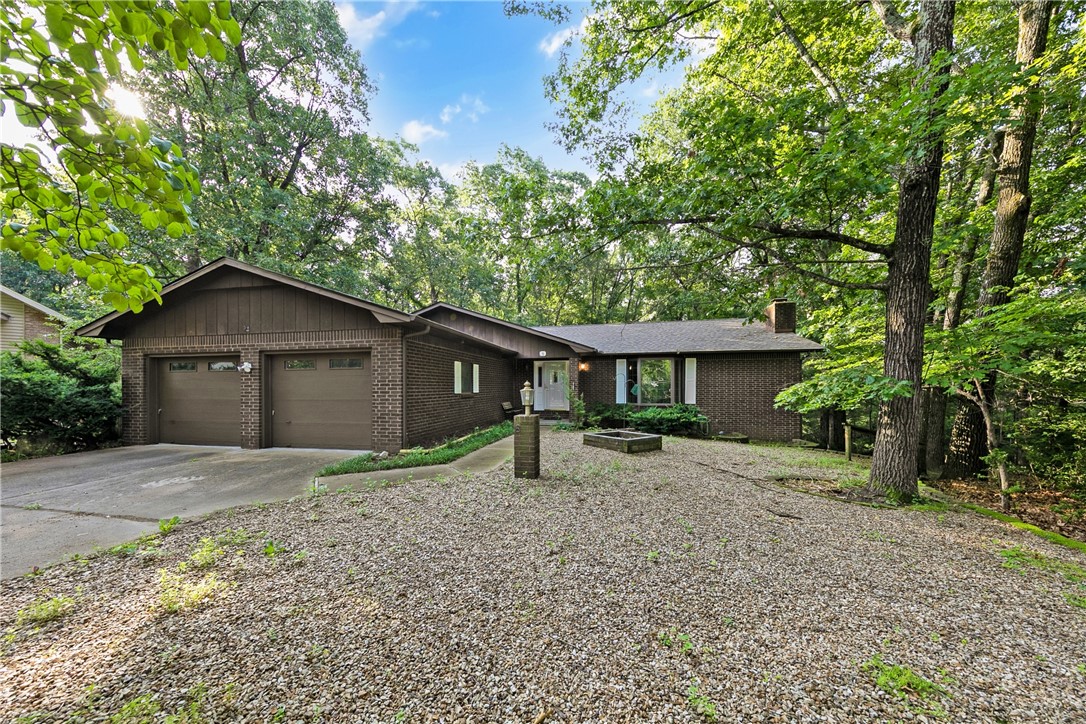 Spacious home in great CUL DE SAC location with a DOUBLE LOT! So many great features include 2 Fireplaces, Formal and Casual eating areas, Living Room & Family Room, Full SCREENED IN DECK across rear of home, Walk out basement and a giant WIRKSHOP / HOBBY area in basement too! Very large Kitchen has a CENTER ISLAND with butcher block prep area. Large Laundry room has a cooktop so is a partial kitchen for downstairs use! Rear yard has a fenced area for a pet also. Lovely, wooded view features lots of wildlife! Second lot is LEVEL in front and very buildable for another garage or shop separate from this home. Currently, the house is on a 2 BR septic, but SELLER IS PAYING FOR NEW SEWER! Home is well built and has a NEW ROOF in March of 2025! Also it has some handicapped amenities if needed. Trails are nearby and other community amenities in the METFIELD area of Bella Vista!