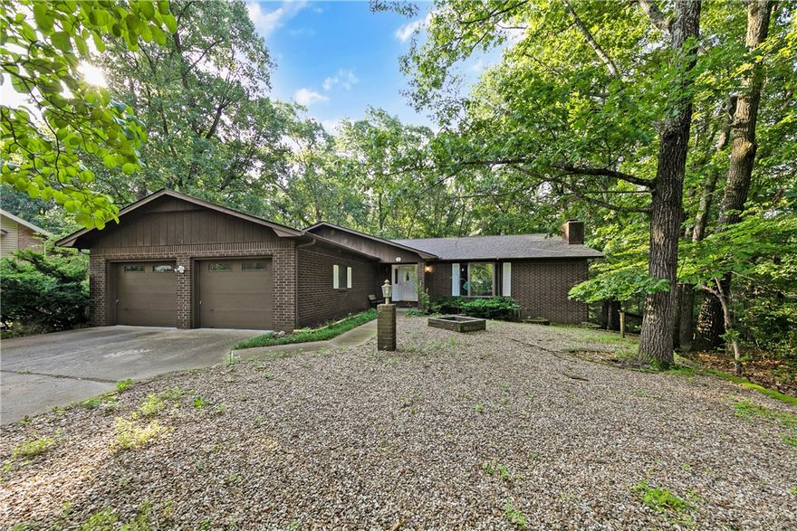 Spacious home in great cul de sac location with a double lot! So many great features include 2 Fireplaces, Formal and Casual eating areas, Living Room & Family Room, Full screened in Deck across rear of home, Walk out basement and a giant Workshop/ Hobby area in basement too!  Very large Kitchen has a center island with great butcher block prep area.  Large Laundry room has a cooktop so is a partial kitchen for downstairs use! Rear yard has a fenced area for a pet also.  Lovely wooded view features lots of wildlife! 
Second lot is level in front and very buildable for another garage or shop separate from this home.  Currently  house is a 2 BR septic but is on the Sewer conversion list. Sewer cost to be negotiated.   Home is well built and has a NEW ROOf in March of 2025!  Also it has some handicapped amenities if needed. Trails are nearby and other community amenities in the Metfield area of Bella Vista!