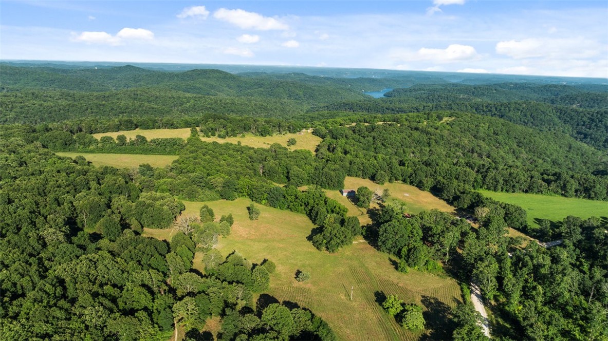 Endless Possibilities on 39+ Acres in Northwest Arkansas! Discover the beauty and potential of this 39.1 acre property that backs up to the Devil’s Eyebrow Natural Area a breathtaking stretch of protected Arkansas land known for its scenic views, wildlife, and outdoor recreation. Whether you're dreaming of a peaceful homestead, hobby farm, or hunting retreat, this versatile land delivers. Property features a 1,800 sq ft manufactured home. The true highlight is the land itself: a mix of open pasture and mature woods, featuring enormous dogwood trees, rich wildlife presence, and endless room to roam. A large 4 bay workshop/garage provides plenty of space for equipment, storage, or hobby use. Also listed under MLS 1312696