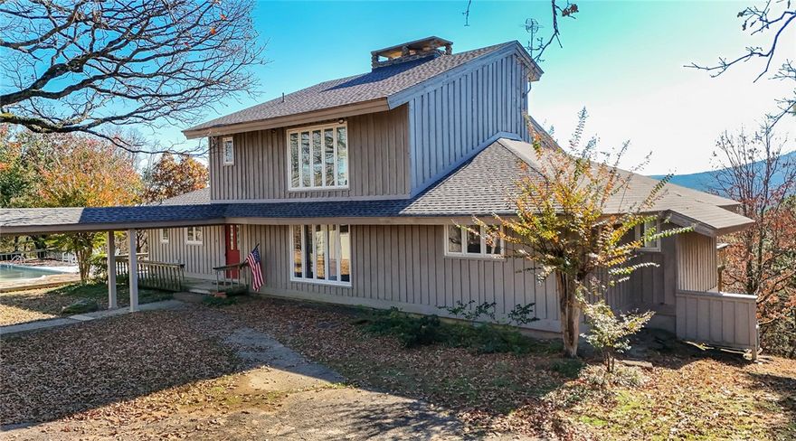 This home offers breathtaking mountain and lake views. Located near some of the most sought after outdoor destinations. Just minutes from Monument Bike Trails, Mt Nebo State Park, Lake Dardanelle, and the Lions Den, this property is perfect for outdoor enthusiasts. The home features 3 beds, 2 1/2, baths.  Living is highlighted by cathedral ceilings, built-ins, and fireplace. Den with built-ins. Open kitchen and dining.  Large deck and inground pool ideal for taking in the stunning surroundings. Main Bedroom with fireplace. Carport with attached shop offering extra storage and workspace.