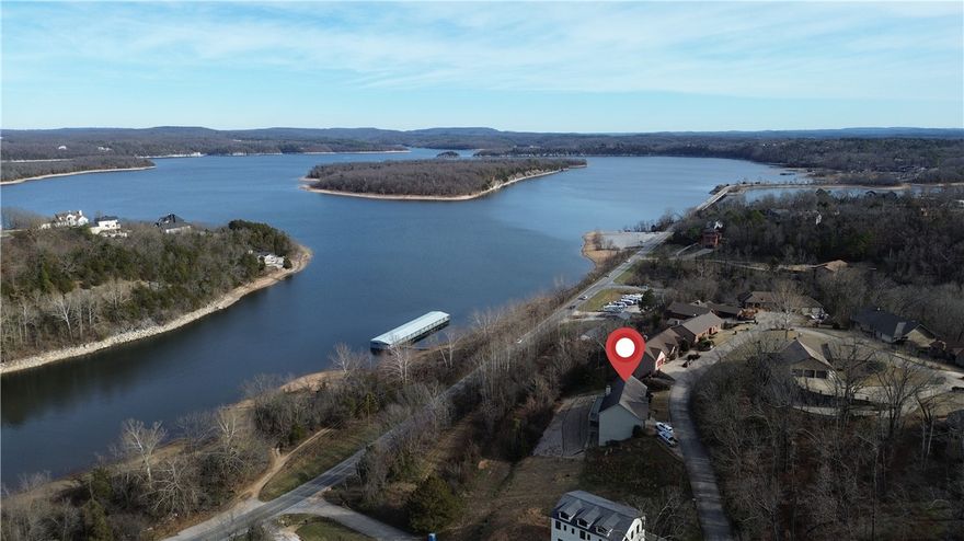 Wake up to beautiful scenic views of Beaver Lake! This home has been meticulously maintained, provides a functional and inviting layout that offers great entertaining space both indoors and out. The main level features a well appointed kitchen with amazing views, a large living room overlooking the lake, separate dining room, oversized utility room, half bath, and primary bedroom/bathroom. The finished basement offers 2 additional bedrooms, full bathroom, a game room/2nd living room with kitchenette, plus a space perfect for home office or exercise room. Walk-out access to the 2 story deck from either level. 36" doors throughout. Surrounded by the natural beauty of Northwest Arkansas, this property offers a peaceful setting just minutes from Downtown Rogers.