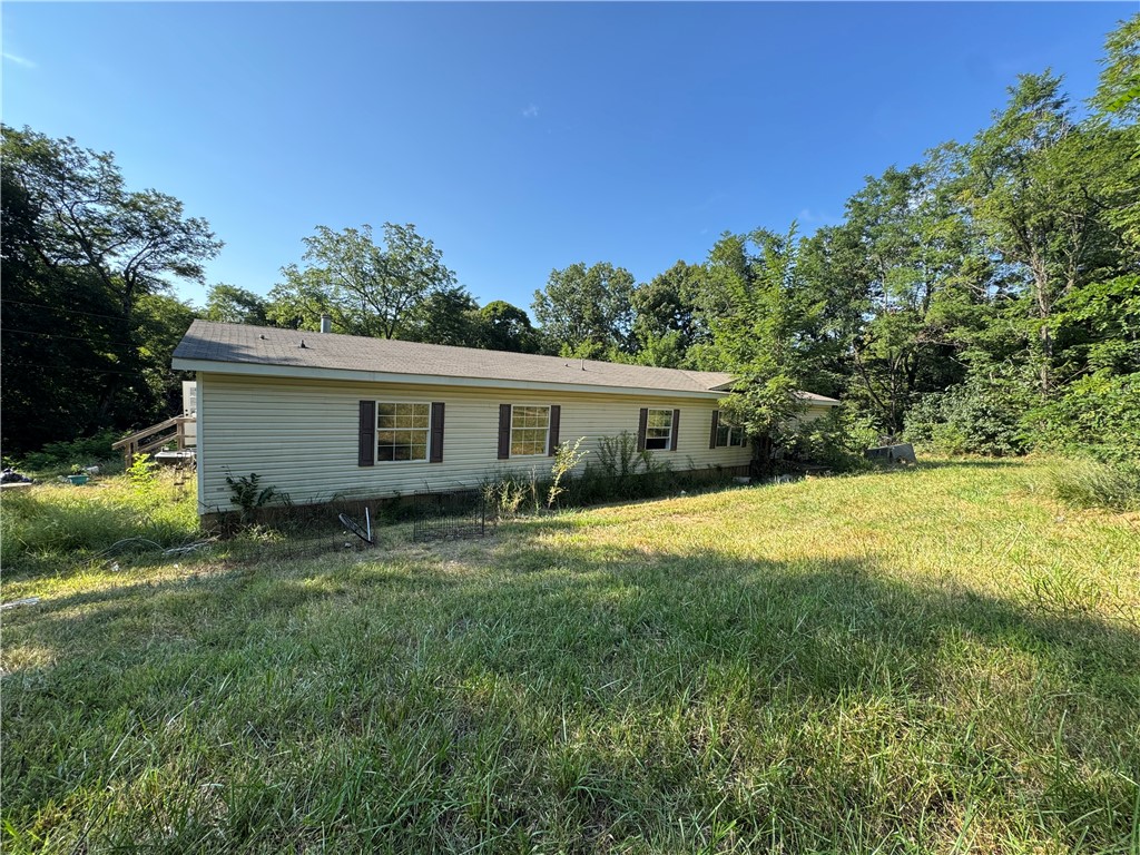 Country living on 1.24 acres. Offering plenty of space and potential, this property is perfect for someone looking to put in a little TLC and make it their own. Enjoy the peaceful setting with room to have a garden or chickens.