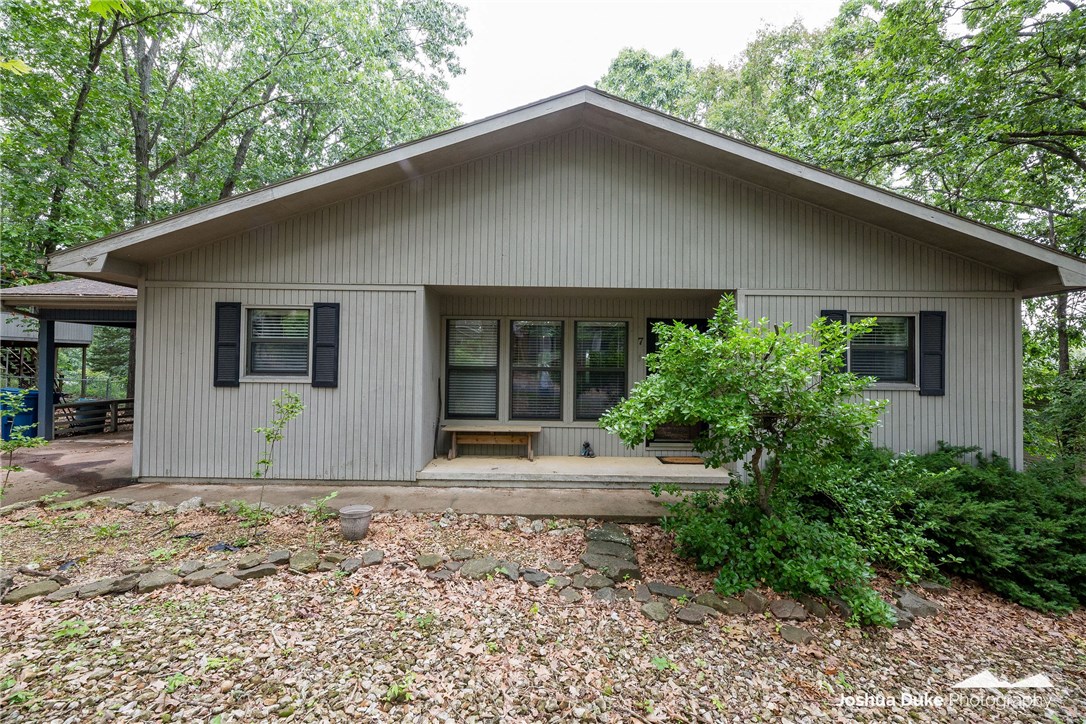 Over 1,400 square feet of open loft style living all on ONE FLOOR with vaulted ceilings Jacuzzi tub, & stone fireplace with gas insert. Recently updated kitchen has backsplash, granite countertops, and butcher block island. The elevated and covered back deck spans the entire width of the house leaving plenty of room for relaxing/entertaining while surrounded by tall trees providing seclusion. This is your chance to own an updated home within a booming market less than 10 minutes from Bentonville.