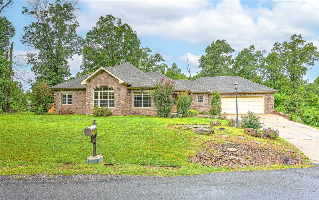 BACK ON THE MARET, NO FAULT OF SELLER Plenty of privacy and space to breathe. The house is conveniently located on the west side of Bella Vista and sits on 2 lots totaling 0.62 acres on the corner and in a culdesac. With a little elbow grease, this home could be your entertainment oasis. The outdoor space is complete with an outdoor kitchen, fire pit area, covered patio and plenty of deck space. Hot tub conveys. Outdoor shed with water and electricity as well as fenced in garden space to keep the deer away. Lawn is irrigated in the front and back. New roof July 2023 with transferable warranty.