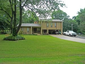If you are looking for a country setting within minutes of town, here it is! This 3 bedroom home features a living room with wood burning fireplace, nice laminate flooring in living and dining areas, and a separate office located on the lower level. All of this is located on a 1 acre wooded lot with mature trees and privacy. The covered deck and fenced backyard is perfect for relaxing and pets. Lots of storage with a 20x10 air conditioned work/storage area PLUS a 20x10 storage building. New roof in 2021, freshly painted exterior, and 4 ton HVAC system installed in 2017. Come and see!