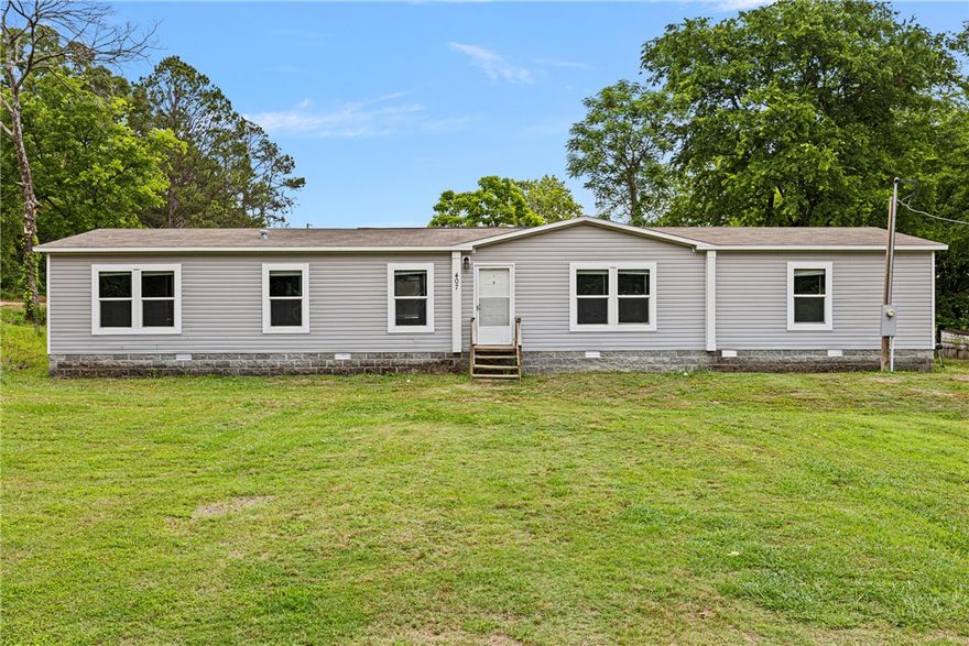 Welcome to 407 N Main Street in Ola, AR! This beautifully maintained 4 bedroom, 2 full bathroom manufactured home offers space, comfort, and modern living all in one. Sitting on a professionally installed permanent foundation with attractive brick skirting, this home is only 6 years old and move-in ready for its next owner! 

Step inside to a spacious split floor plan featuring a large living room perfect for relaxing or entertaining. The open dining area flows seamlessly into the kitchen, giving the home an inviting feel with plenty of room for gatherings. The kitchen offers ample cabinet space, a walk-in pantry, and easy access to the laundry room for everyday convenience. The primary suite features walk-in closets and a relaxing jetted bathtub ideal for unwinding after a long day. With generous bedroom sizes, modern finishes, and a functional layout, this property is ready to welcome you home. 

Schedule your showing today!