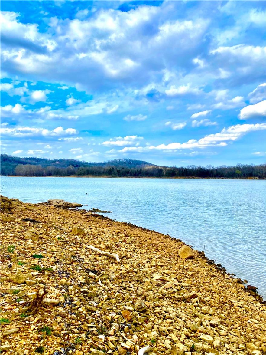 22 acres of private, waterfront land on Table Rock Lake with several build-ready sites. 850 ft +/- walk-to-water shore has near-level access—perfect for fishing, swimming, or launching kayaks from your backyard.   
Located at a prime confluence, a few hundred ft from a State Boat Ramp and just minutes from two full-service marinas.  
850 ft +/- Hwy 311 frontage allows easy entry for hauling boats, luxury RVs, construction or farm equipment.  
Ideal for a lakefront manor, family compound, premium RV camp, or potential airstrip. 
Ample acreage for pastures, grazing, or sustainable homesteading.  
Rural water and electric on-site.  
20 Minutes to Big Cedar Lodge & Top of the Rock for fine dining and golf.  
Easy drive to Bentonville & Northwest Arkansas corporate hubs.  
Near Branson, MO and Eureka Springs: specialty shops, art galleries, and entertainment.  
Additional Acreage Available! —Includes 3BR/2BA residence, a 40x50 Metal Shop/Garage, a Barn, and even MORE lakefront and highway frontage.