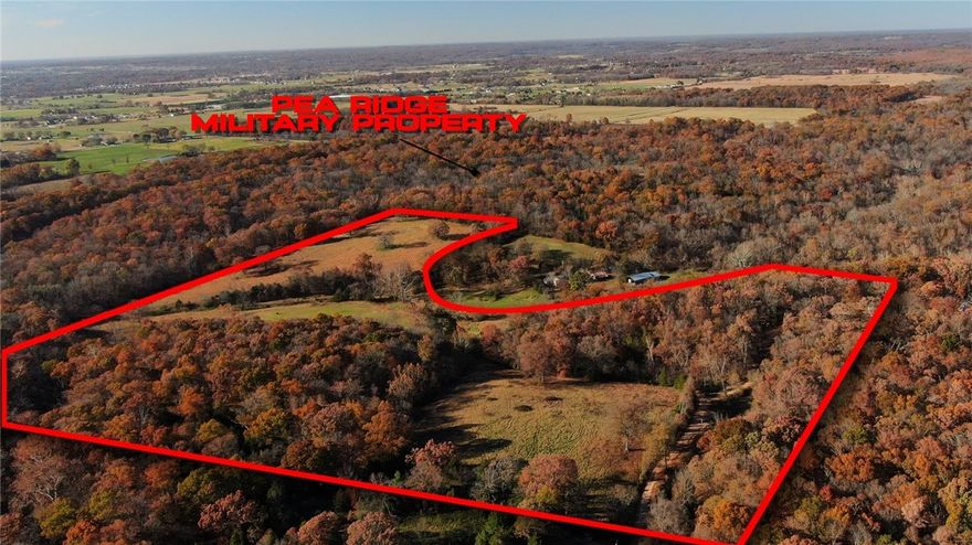 A rare opportunity to own 53.99 acres just off Hwy 62 in Rogers—offering the space you want with the convenience you need. This property borders the Military Park and features three open pastures, wooded areas, and a wet-weather creek that winds through the land. Whether you’re looking for agricultural use, livestock space, or a private homesite, this land offers endless opportunities to build your vision. Recently surveyed. Public water is available at the road. Acreage this close to town with this much versatility doesn’t come along often. NO Deed Restrictions.