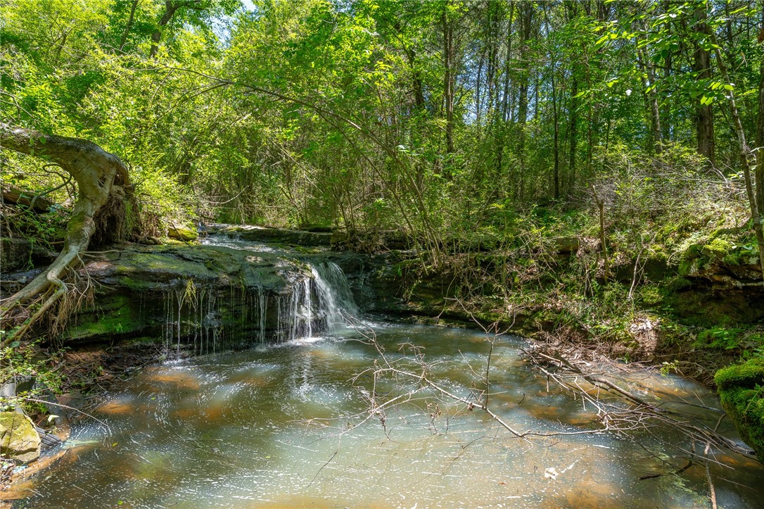 Discover your own private slice of nature on this stunning +/- 8-acre property located on Kenner Chapel Road in Rudy! This unique tract offers incredible natural features including a natural spring and a waterfall—perfect for anyone seeking tranquility and beauty in their backyard. Outdoor enthusiasts will love the prime hunting opportunities this land provides, with abundant wildlife and wooded areas offering privacy and adventure. Whether you're looking to build your dream home, set up a weekend getaway, or invest in recreational land, this property is a rare find that combines natural charm with outdoor potential. Don’t miss this opportunity to own a piece of Arkansas paradise!