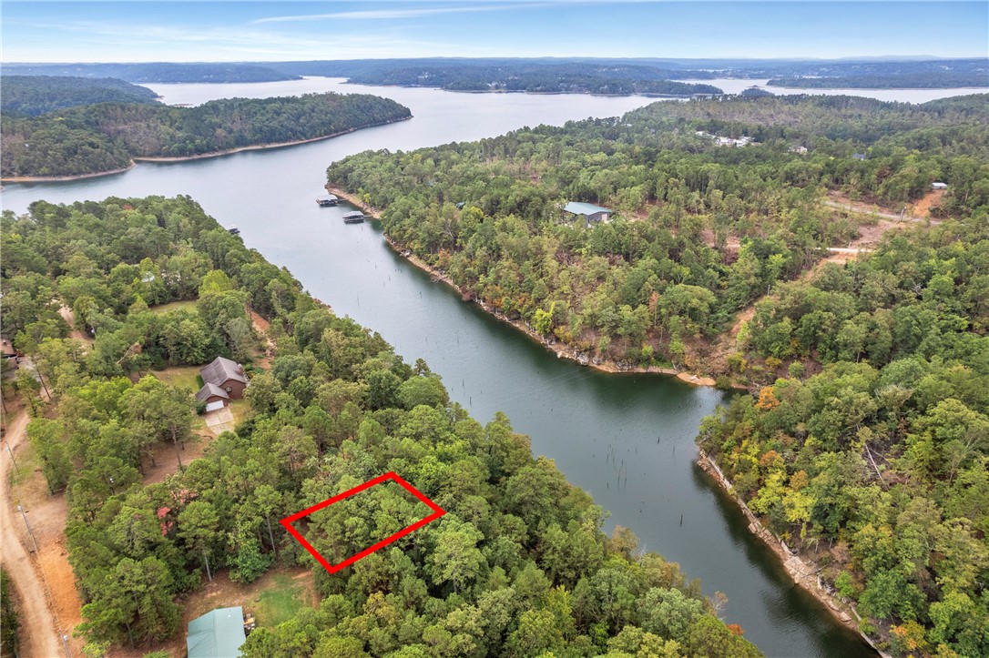 Discover your own piece of paradise with this beautifully wooded .19 acre lot tucked away on one of Beaver Lake's cove fingers. Imagine waking up to serene water views and enjoying easy access to all the outdoor activities that this lot has to offer.
