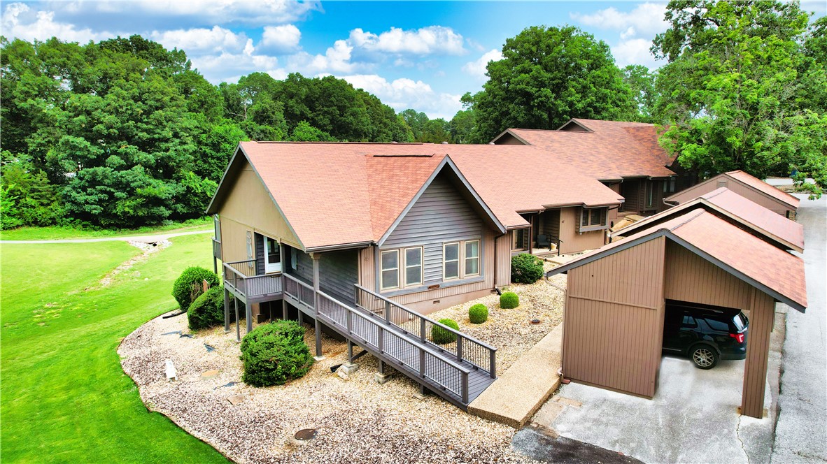 Welcome to your ideal retreat, where the allure of outdoor living meets the comforts of home. Nestled along the Brittany golf course in Bella Vista, and just steps away from the renowned Blowing Springs greenway, this charming townhome offers the perfect blend of convenience & adventure. Boasting a coveted location within the esteemed Bentonville school district, this well maintained one-level home features 3 bedrooms, 2 baths, & an abundance of storage space. The detached 2-car carport with additional storage ensures ample room for all your recreational gear. Embrace the maintenance-free lifestyle you've been dreaming of, allowing you more time to indulge in the array of amenities at your doorstep. From lively rounds of pickleball/ tennis to leisurely strolls to the playground & pavilion, there's something for everyone in this vibrant community. Whether you're teeing off on the golf course, hitting the trails, or simply soaking up the sunshine by the pool, you'll feel right at home in this idyllic oasis.