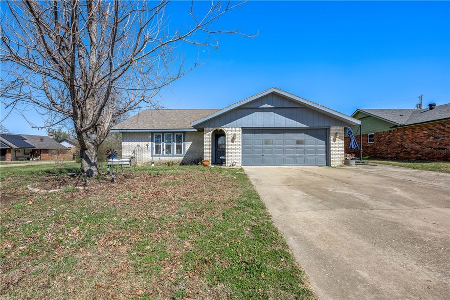This charming single-story home offers comfort, character, and a welcoming feel from the moment you arrive. The front exterior features a spacious driveway, mature trees, and a classic curb appeal in a quiet, established neighborhood.
Inside, you’ll find a warm and inviting living area with vaulted ceilings, a cozy stone fireplace, and plenty of natural light—perfect for relaxing or entertaining. The open layout flows seamlessly into the dining space, creating an easy, functional living environment.
The kitchen is both stylish and practical, with rich wood cabinetry, modern stainless steel appliances, and ample counter space for cooking and gathering. Unique ceiling details add personality and charm to the space.
With its blend of comfort, character, and livable design, this home is a great opportunity for anyone looking for a cozy place to call their own.
To give buyers added confidence, the seller is including a home warranty with purchase—providing peace of mind as you settle into your new home.