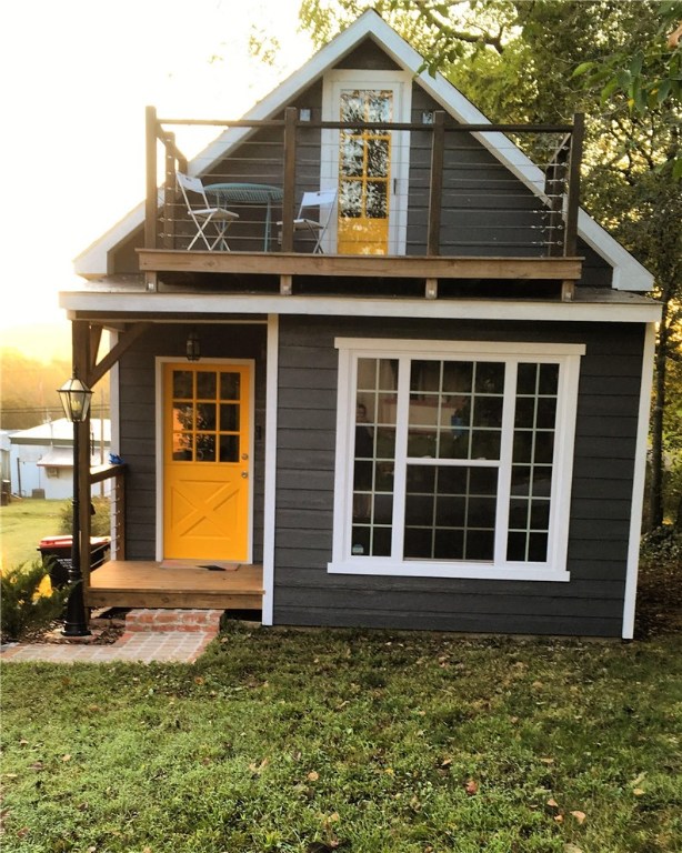 Great things do come in small packages! This rare find only a short distance to Bentonville via new bypass won't last long! So many details put into this amazing home, from the unique front dutch door to the recycled wood flooring and wall to the spiral staircase. Whether you are enojoying evening sunsets on the upstairs patio or binge watching Netflix in the quaint living room, this house will make you smile. Welcome home.