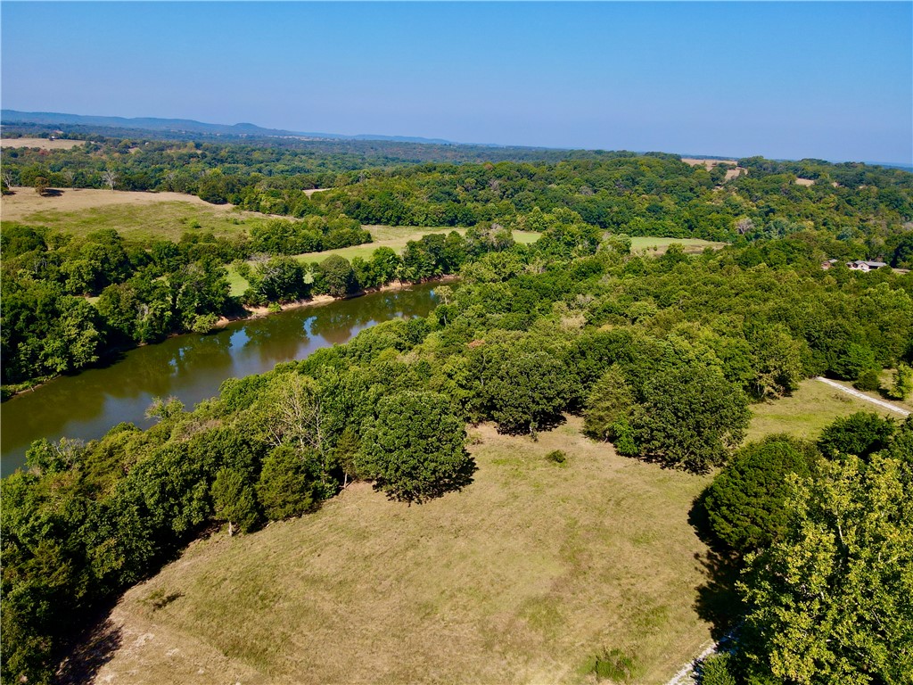 10.41+/- surveyed acres with 600 feet of Kings River Corps frontage. This land is the perfect canvas for your dream home or a tranquil getaway. The property has multiple build sites, each offering stunning river views, ensuring that you can create the perfect setting to take in the natural beauty surrounding you. This property is not only picturesque but also practical, with a successful septic perk test already completed for a 4-bedroom home. Electricity is already on the property, making it easier to start building your dream home. The land has a harmonious mix of pasture and timber, offering both open space and wooded areas. For the outdoor enthusiast, the Kings River offers fantastic kayaking and fishing opportunities right at your doorstep. Despite its secluded feel, this property is located just 11 miles from both Berryville, AR, and Shell Knob, MO. If you're looking for an opportunity to do some boating it's a mere 12 miles to multiple boat ramps at either Eagle Rock Marina or Shell Knob on Table Rock Lake.