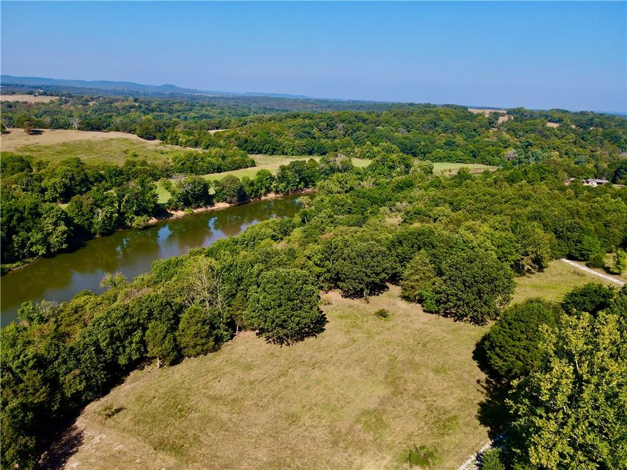 10.41+/- surveyed acres with 600 feet of Kings River Corps frontage. This land is the perfect canvas for your dream home or a tranquil getaway. The property has multiple build sites, each offering stunning river views, ensuring that you can create the perfect setting to take in the natural beauty surrounding you. This property is not only picturesque but also practical, with a successful septic perk test already completed for a 4-bedroom home. Electricity is already on the property, making it easier to start building your dream home. The land has a harmonious mix of pasture and timber, offering both open space and wooded areas. For the outdoor enthusiast, the Kings River offers fantastic kayaking and fishing opportunities right at your doorstep. Despite its secluded feel, this property is located just 11 miles from both Berryville, AR, and Shell Knob, MO. If you're looking for an opportunity to do some boating it's a mere 12 miles to multiple boat ramps at either Eagle Rock Marina or Shell Knob on Table Rock Lake.