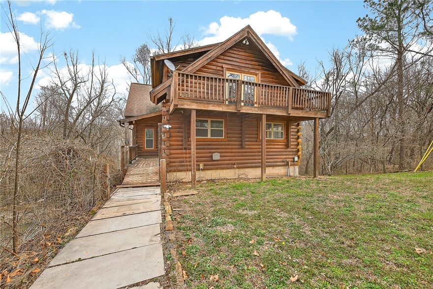 This charming and secluded log cabin sits on 6.96 acres just 8 miles from I-49, offering privacy with convenience. The current 2,158 SF of living space needs some updating and finishing in areas but provides incredible upside potential. Perfect for an investor, builder, or DIY enthusiast looking to add value. The partially finished, partially climate-controlled basement offers approximately 1,000 additional square feet that could be built out for expanded living space. It already includes a pre-plumbed bathroom, utility sink, and washer/dryer connections, creating the opportunity for a completely separate living area or guest quarters. Priced well below appraisal, this property presents an outstanding investment opportunity!