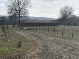 Yell County Farm- Home & 55 acres Beautiful setting below Mt. Magazine. Home features approx. 2050 sq ft., 3BR, 2BA, study with built-in shelves, sunroom, abundant storage and generator for home for those emergencies. Sit in the front yard and enjoy the serene country side. Pasture is level and open,two ponds, old barn with character, shed, storage building. Perfect for your cattle or horses.