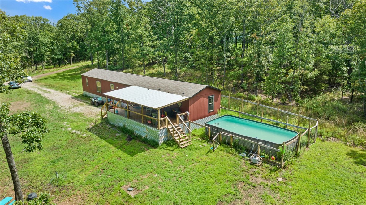Welcome to your slice of country paradise! This 14.64-acre property is made of three separate parcels-offering a rare opportunity for both peaceful living and income-producing potential. Whether you're looking to hunt, invest, or simply enjoy the quiet rural life, this property checks all the boxes. The well maintained 3 bed, 2 bath mobile home is full of charm, featuring a newly extended front porch, perfect for relaxing and taking in the views. Step out back to a fenced yard, ideal for pets, a refreshing swimming area, and room to garden or entertain. The home is also equipped with solar panels, keeping energy costs low and sustainable living high! Outdoorsman and nature lovers will appreciate the prime hunting and with frequent sightings of deer, foxes, and bobcats. One of the additional parcels offers lot rent income, making this a smart investment with built-in revenue. There's also a large shop building for storage, hobbies, or future expansion. Don't miss the chance to own this versatile country property!
