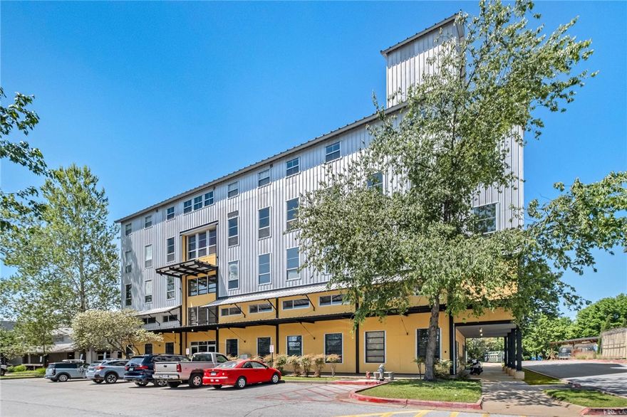 Unit 450 at 525 S School Ave offers a rare chance to own a piece of Fayetteville history. Originally built in 1950 as a bustling industrial feed mill, this landmark structure has been reimagined as the heart of the vibrant Mill District. Available for the first time in years, this authentic loft-style residence delivers a low-maintenance, modern lifestyle in an unbeatable location.The interior showcases soaring ceilings, exposed metal beams, and concrete floors. The unique two-level layout maximizes functionality, placing the bedroom and bath on the main floor and the kitchen and living area above. Positioned directly on the Razorback Greenway, you are steps from the Lower Ramble, Cultural Arts Corridor, and the Entertainment District. This prime location offers immediate access to the dining and entertainment of South Yard, The Mill, and Prairie St placing the best of downtown Fayetteville right at your doorstep.