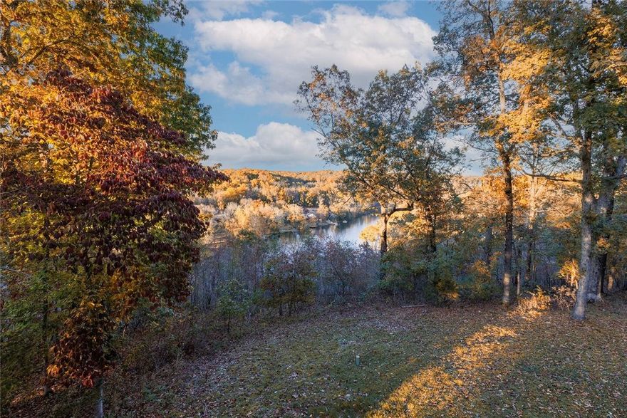 Dreamy Lakeview Retreat on Lake Ann – Turnkey Investment! Discover a rare opportunity to own a fully furnished, income-producing short-term rental on Lake Ann in Bella Vista, this one-of-a-kind home is a proven Airbnb favorite, offering instant cash-flow potential. This spacious retreat features 5 large bedrooms + office/flex space, 3 full bathrooms, 2 living areas, 2 full kitchens and 2 laundry rooms, making it ideal for larger groups or multi-generational living. With its split-floor plan on each level, privacy and comfort come naturally. The primary suite is a true sanctuary with lake views, oversized spa bathroom, and 3 spacious closets. Sunlit living and sunrooms showcase year-round panoramic lake views. Step outside to a handicap-accessible wraparound deck, private hot tub, and outdoor oasis. Close access to Back 40 and Summit School trails, with the Lake Ann boat ramp just 5 minutes away. New roof (2021), septic pumped & inspected (2023). Offered fully furnished for seamless Airbnb operations.