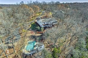 Lake front home, with three boat slips to convey in a semi-private dock. (One 10x30, Two 10x14). This amazing lake home is surrounded by trees on nearly 7 acres. Wonderful lake view from either the sunroom or the upper and lower back decks. Lots of room for family and entertaining, with a vaulted LR, formal dining room, a second living room, and eating area downstairs. Want to be outside more? Enjoy the in-ground pool, outdoor bar in its own building, boating, fishing and more! Home is just minutes form Prairie Creek Marina and Rogers. This beautiful property is currently being operated as an AirBnB and is booked often and it has been a good money maker. But Seller will work it out if the Buyer is buying it for a personal home and wants to discontinue the AirBnB. Furnishing to convey to Buyer with acceptable offer. You won't find a better value anywhere on Beaver Lake than this home, pool, acreage and boat slips. Check it out!