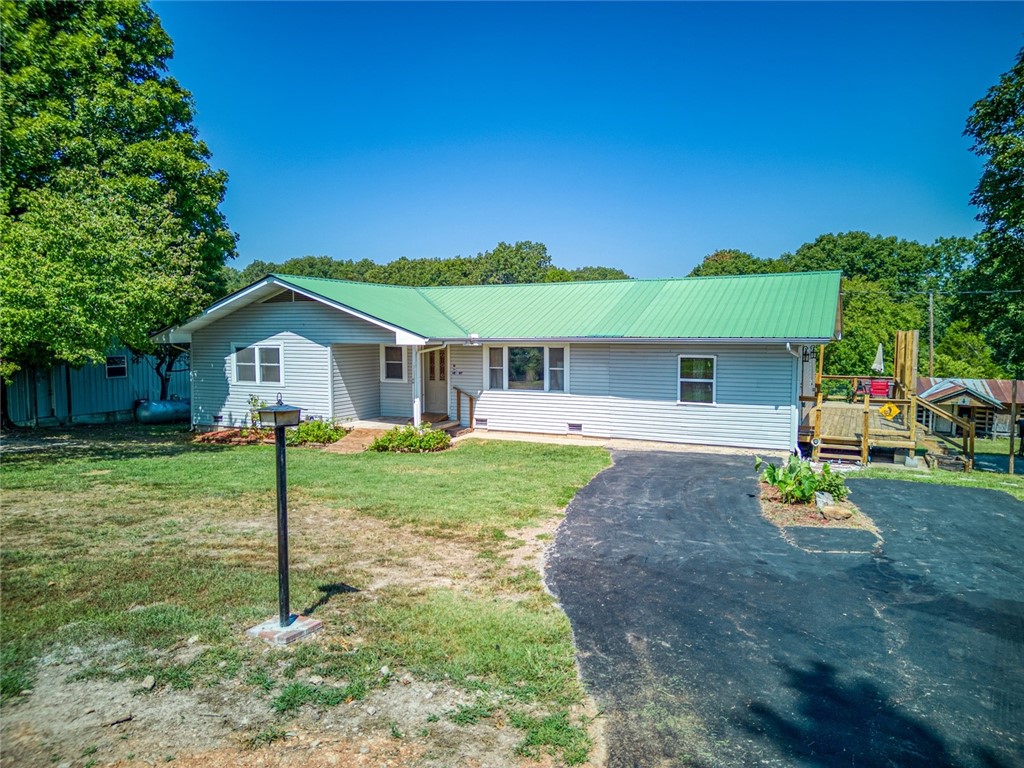 Located in the Ozark Mountains you will find this wonderful property only 3 minutes away from the Buffalo National River that features 4 bedrooms, 1.5 baths, a 1,500 shop building with electric, 3.83 partially fenced acres with no restrictions, the original homestead, another shop building with electric and an additional outbuilding. The views from the newly finished deck are breathtaking! Additional features you will love; original hardwood flooring, big picture windows, back up heat source, the large living room and dining room that has recently been added bringing the square footage up to nearly 2,000 and the asphalt driveway! This property is the Ozark mountain getaway you've been looking for! Make this your hunting cabin, your hobby farm residence, your rental or vacation home