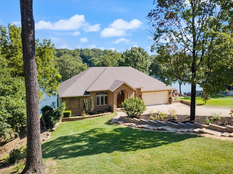 relax and enjoy 289' of hard to find easy access Lake Front -multiple usable grass areas - expansive lake views from most rooms - left side lot gives you wooded privacy - right side lot has terraced firepit and BBQ area - very livable and flexible floor plan with tall ceilings, upgraded trim, recessed lighting and Pella shades inside windows - great floor plan for entertaining, with lots of spots to curl up with a book - Primary bedroom features two way fireplace, tray ceiling, lake views with deck access, dual vanity bathroom with walk-in shower and whirlpool tub - 27' heated and cooled sunroom -lower level has kitchen open to large family room - pantry/safe room - 2 bedrooms - bath with walk-in shower - another 27' sunroom right on the lake, plus an exercise room or craft room -large decks with glass railings - storage for John Deere riding mower which is included - sprinklered from lake -move right in and enjoy the wonders of lakeside living - three bedroom septic - house rebuilt from foundation up in 2007-2008