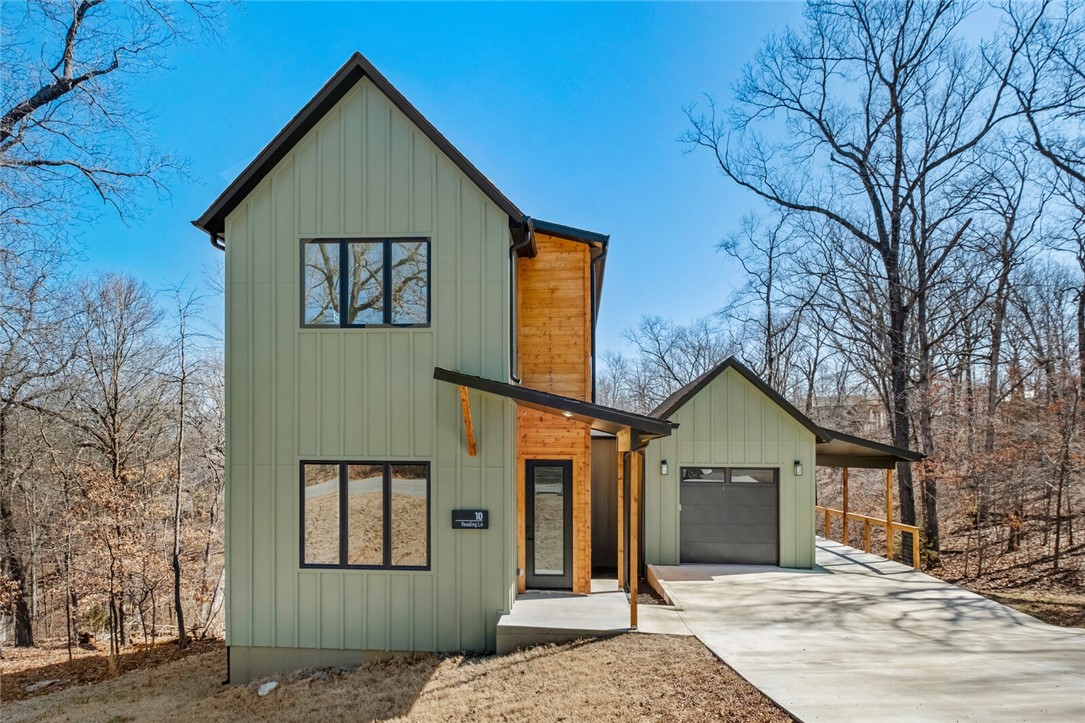 Luxury modern home in an amazing location! This home sits across the street from The Back 40 Trail! Minutes from multiple golf courses, lakes and pools. Inspired by the surrounding Ozark forest landscape, this stunning two-level modern home embodies everything you love about Bella Vista living. Highly efficient floor plan features two spacious bedrooms, two bathrooms and an abundance of nature views. Enjoy your vaulted living room with abundant windows looking out onto those Ozark views. Outfitted with a back deck, you'll move seamlessly between your comfortable indoor space and your very own outdoor living area. Think twinkle lights, a BBQ and lots of cozy nights wrapped in a blanket among the trees. Luxury interior finishes includes LVP throughout the first floor, quartz countertops in the kitchen, matte black fixtures, smooth walls, and so much more.
