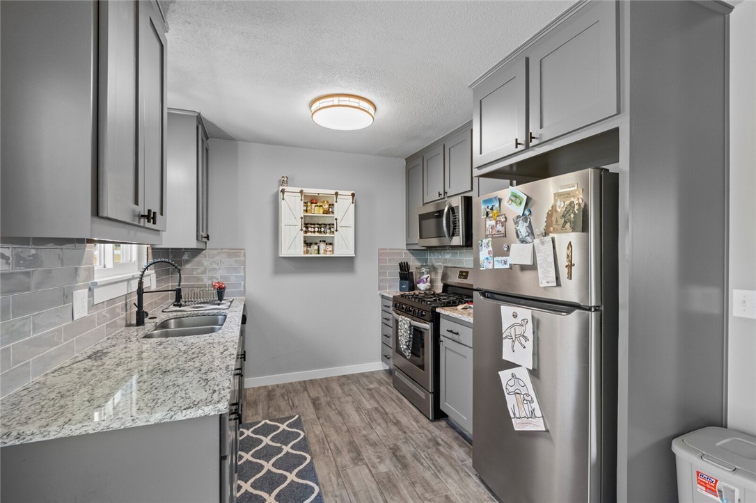 This beautiful remodel is in the heart of Rogers! With itās stunning remodel and numerous updates, it offers a modern and inviting living space. Updates include wood- looking tile Flooring in Main Living Areas, New Cabinets, Gorgeous granite Counters Throughout, All New Lighting, Hardware, Roof, Windows, HVAC, And More! Three Bedrooms Including a Primary w/ Attached 1/2 Bath. Full Hall Bath Has Tub/Shower with Tile Surround. The garage has been converted to a large laundry room which also creates additional flex/ storage space. Large back yard with a nice sized storage unit. This home is ready for move in and easy to show! Refrigerator conveys.