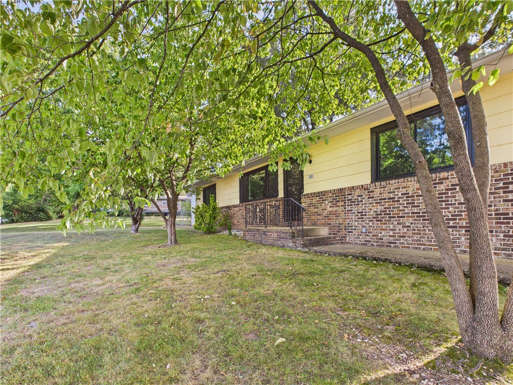 Spacious and well-maintained 4 bedroom, 2.5 bathroom home located in the heart of Harrison, Arkansas. This property features numerous recent updates, including a new chimney and flue for the wood-burning fireplace (2020), new Anderson windows (2020), a new roof (2021), new gutters (2022), and new flooring (2025).. The detached garage is equipped with electric, heating, and air conditioning, making it ideal for a workshop or additional storage. The fenced yard provides space for children or pets. This home also includes a dedicated office space, perfect for remote work or study. Conveniently located just minutes from shopping, schools, restaurants, and parks, this property offers the perfect blend of comfort and convenience.