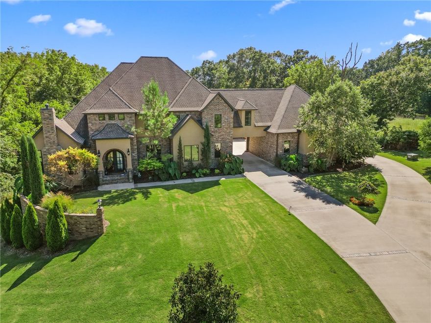 Welcome to your private 6.5 acre estate located in Talamore. An evergreen tree-lined driveway gently
curves toward the home-site. Built in 2017, this custom home offers the perfect blend of modern elegance
and serene living. An inviting 45’x20’ heated, saltwater lounging pool extending to a depth of 8’. A private
setting, the property's meticulous details make it an exceptional place to call home. Featuring custom
hardwood floors, professional kitchen, large capacity refrigerator, warming drawer, built-in coffee maker.
Owner’s suite has two walk-in closets, spa bath with heated floors and quartz counters throughout 
home. Within minutes of world class bike trails, downtown Bentonville. Conveniences include: Close
proximity to I-49, municipal & national airports. Approximately 667 ft.² included heated and cooled
space is garage bay finished as workspace with kitchen and half bath plus walkable garage storage space under the house + whole house generator. Listing includes parcels 15-16352-000 and 15-16355-000