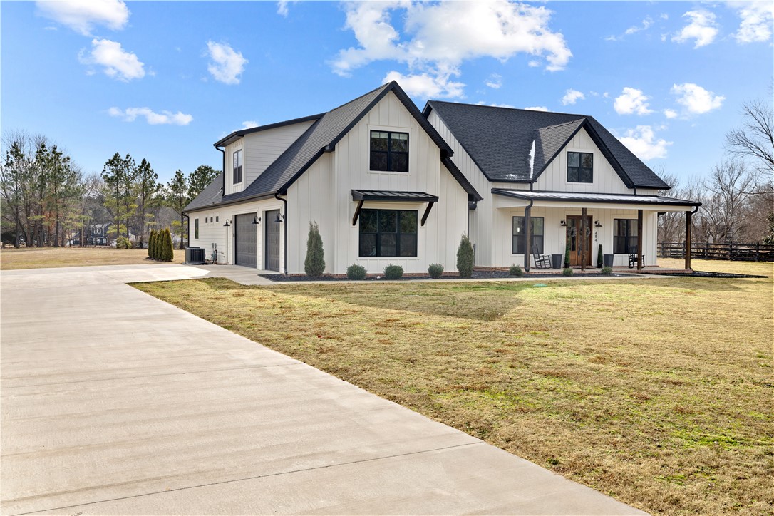 Gorgeous modern farmhouse custom built in 2019 sitting on 2 acres in east Fayetteville / Goshen! 3394 SF main home w/ Master on main plus 2 other bedrooms. Bonus room / 4th bedroom upstairs. 950 SF 3 car garage. The kitchen is ready for entertaining guests, has tons of storage + a huge walk pantry. The master is a gorgeous oasis split away from the guest rooms + has a big master closet attached to the laundry room. The pool house is 1700 sf & features a full kitchen, living room and two beds w/ full baths. The 1000 sf shop is at the end of the hallway & has a full bay door plus another side garage for yard implement storage or bonus toys! The 18' x 36' sport pool will make your house the one to be at this summer the covered 50' x 16' patio on the pool house will allow you to escape the western afternoon sun! Properties like this one do not hit the market often so call today to set up your private tour before this one is sold!