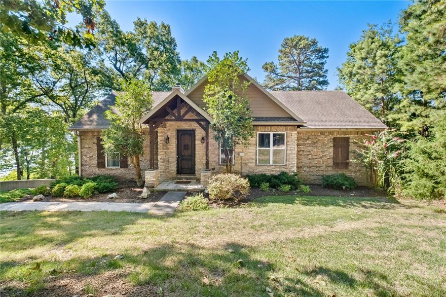 Tucked away at the end of a quiet cul-de-sac is a beautifully sited, 1.16 acre waterfront retreat that takes full advantage of the breathtaking Beaver Lake views. The open floor plan boasts 2,728 sq ft of gracious living area, perfect for entertaining. The main level features 3 bedrooms, 2 full baths & vaulted wood-beam great room that opens to the kitchen & dining areas. Off the great room features a newly added screened-in porch with a tin roof offers a peaceful getaway. The lower level houses a spacious 2nd living area or fun bunk room, full bath & generous laundry room. The expansive property includes mature trees, paved golf cart path to the corp line for easy access to the lake, private family boat dock & multiple points of water access for kayaks & canoes. This remarkable property is located along a peaceful cove & offers 2 boat slips, 2 jet ski slips & expansive swim deck. Conveniently located 15 minutes from downtown Rogers & offers plenty of space for guests w/oversized 2 car garage & extra parking pad!