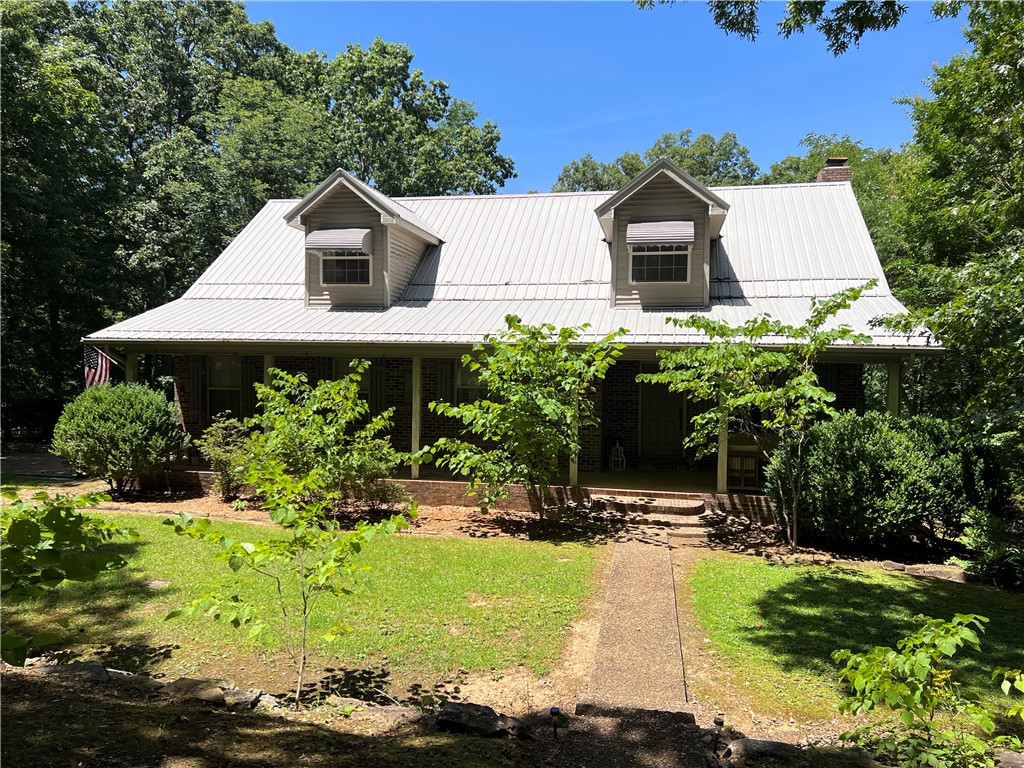 Spacious and private 3,398 SQFT country home with 4BR-3.5BA on 15 forested acres!! Ample room inside and out for friends, family, gatherings, or as an income producing vacation home (property is currently used as a nightly rental). This accommodating brick home features a wood fireplace, walk-in closets, pantry, hot tub, 3 large covered porches, and metal roof plus the appliances and most of the furniture convey. The full basement provides a great room and 1 car garage/workshop. Outdoor features include a wood shed, fire pit, verdant Ozark views, and a seasonal creek. Only 3 miles to Jasper and close to the Buffalo National River Park.