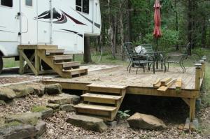 Great views. Triangular tract of land. Adjoins Corp of Engineers property on rear. Great get-a-way property. Includes a 2005 36' Everest RV with 4 slide outs. New HVAC unit on roof. New deck, steps, anddriveway. All furnishings including appliances. Seller is taking loss. Septic will work for a home, nice system, city water, concrete patio, outside water hydrant. Th propane tanks area included. The standard width for a 5th wheel is 8'. The 5th wheel has been on the property for 2 years.