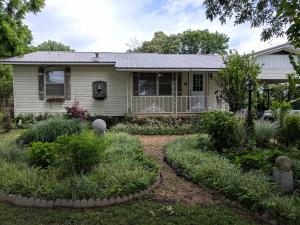 The charm of a country cottage with the benefits of recent updating. Home features 3 bedrooms, 1 bath, large living room, big open kitchen/dining area, hardwood floors, outbuilding and a huge lot, all conveniently located on the south side of town. This home is ready for you!