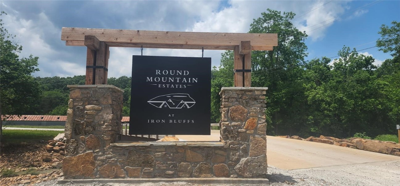 Lot 79 has scattered hardwoods and is perfect for a basement home. Round Mountain Estates is a new development that is only 10 minutes from Harrison Arkansas. This master planned subdivision offers the following utilities: fiber optic internet, public water and sewer, electric, natural gas. Plans include a common area with Kissing Rock Trail, Baby Canyon Trail, towering bluff lines to climb with outstanding views. This area is also close to the Buffalo National River and Branson MO.