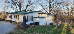 Motivated Seller! Ready for an Offer! Beautiful Country setting with great view! Home has newer roof, windows & siding. Land is mostly pasture with pond. Has Generac back up system. 30x24 shop pole barn, &small finished guest house/shed. Room for a few cows or horses. Hard to find mini farm at this price point.