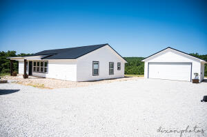 Custom, brand new homestead in the Ozark Mountains! Don't miss out on these breathtaking views, the perfect homesteading setup, and the peace and tranquility that this home has to offer you! Split floor plan, open concept with lots of great natural light and windows for you to enjoy your view! Home features a walk-in pantry, double walk-in closets in the master, custom master bath with a separate custom tile shower and tub and double sinks along with a linen closet, 2-8x20 porches for you to sit and relax on, all tile flooring, baseboards, and window seals, wood/coal stove in the living room, custom granite bar in the kitchen with custom cabinetry, new stainless steel appliances, and large laundry and mechanical room. This home also has a 25x20 2 car garage with lots of