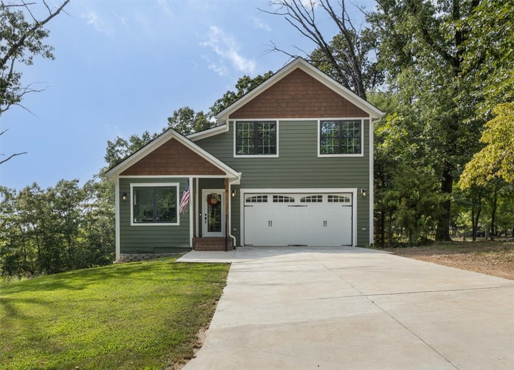 Welcome home to this cozy craftsman style home. Featuring 3 bedrooms and an office, eat in kitchen, hidden pantry, electric fireplace in the living room, an abundance of natural lighting in every room. Enjoy the soaking tub in the primary bathroom, an additional living space or flex room upstairs, and tons of storage. Workshop or basement storage under the house and the covered back deck features a slide for the little ones in your life. Only a couple miles to the nearest mountain bike trail.
