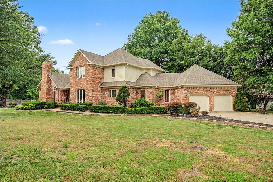 Located near the heart of the Downtown Bentonville district and directly across from bike trails, this beautifully renovated home blends luxury, warmth, and thoughtful design throughout. Soaring 23-foot ceilings create a dramatic yet inviting living area, while the fireplace-centered library, office, or den features custom built-ins and rich character. Elegant hardwood floors flow throughout, complemented by a stylish coffee bar perfect for entertaining. The chef’s kitchen showcases custom cabinetry, premium finishes, and a butler’s pantry for added convenience. Each bedroom includes its own private en-suite bath, creating relaxing retreats throughout the home. Outdoor living shines with an entertainer’s patio that seamlessly extends the living space outside.  Recent updates include a new roof (2019), a tankless water heater (2021), one HVAC replaced (2021), a garage car charger, and exterior paint completed in 2025.