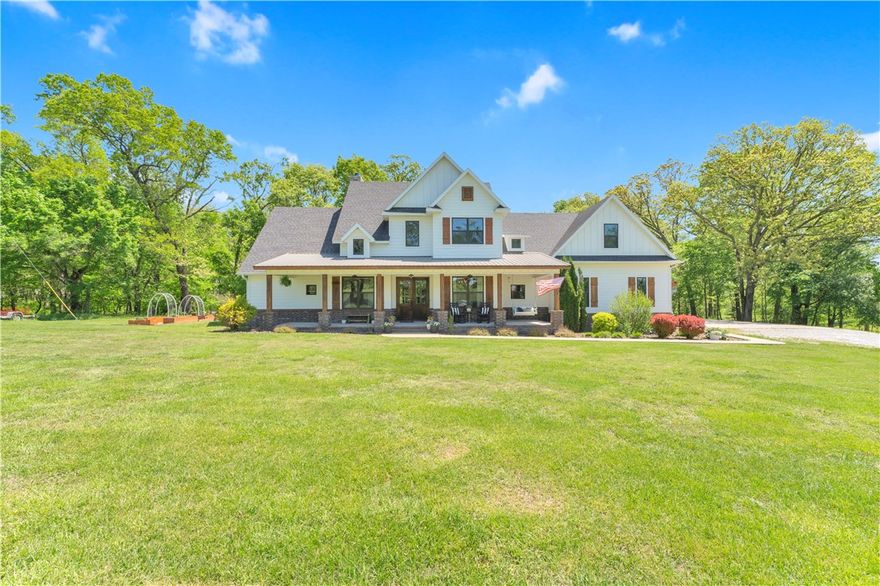 Some homes invite you in. This one invites you to slow down. Set on 5 expansive acres, mornings begin with soft light pouring through expansive windows as the sky shifts from golden to shades of pink and purple. In the primary suite, a picture window and window seat create the perfect place to sip coffee, read, and take in peaceful views of trees, green grass, and deer grazing nearby. Evenings gather around the warmth of the fireplace, where comfort and connection come naturally. The additional acreage offers space to breathe, added privacy, and room to create the lifestyle you’ve been dreaming of. All of this just minutes from downtown Bentonville, the Pinnacle area, shopping, and dining. Preferred lender offering up to 1% of loan amount in credits for qualified buyers. Also available on 3 acres. See alternate MLS listing 1343927.