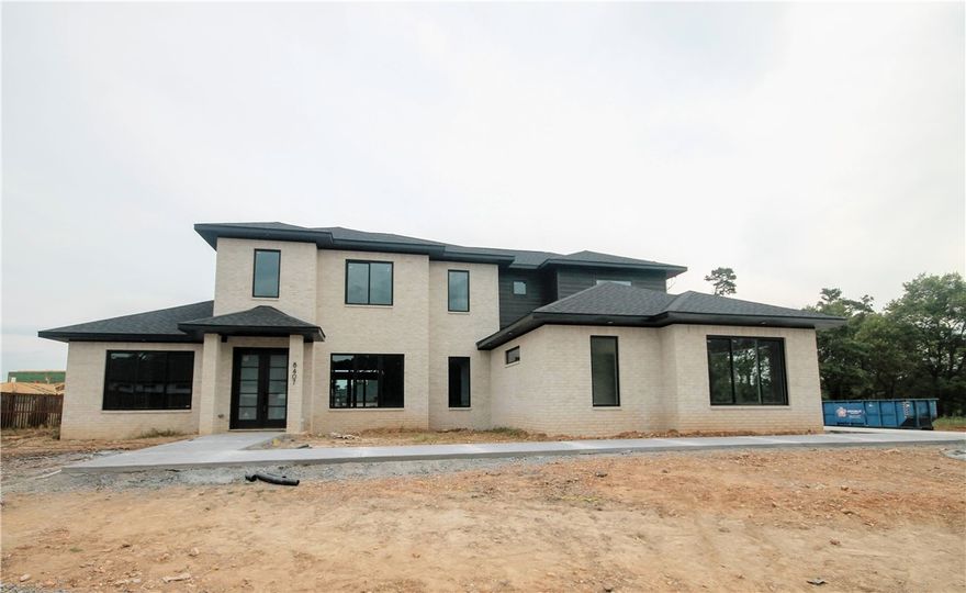 New construction modern masterpiece... Estate home in the highly sought after gated community of Scissortail. 3 car garage, large bedrooms with walk-in closets and their own bathrooms and bonus room with wet bar on the main level! Large open floorplan with TONS of natural light and space to entertain! Large living room with modern tile linear fireplace, floating shelves, 3' plank wood floors and custom stained poplar wood beams. STUNNING bathroom suit with soaking tub with accent stone wall, walk in tile shower and massive walk-in closet with access to the laundry room. Secondary bedroom on the main level with luxurious bathroom. All the features you want including home audio, central vac, Jenn Air appliances with a 6 burner cooktop, griddle, stand alone freezer and refrigerator, trash compactor and double ovens. Enjoy entertaining on the large covered back patio with built in grill!