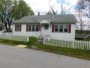 Charm and Character with stained wood trim and arched doorway between living and dining room. Smaller room off living room for office with outside entrance. Home has newer vinyl flooring, partial walk out basement for storage and work area, it appears the basement entrance could have a garage door, carport attached to basement. Tax amount 446.25 is before $350 homestead credit.