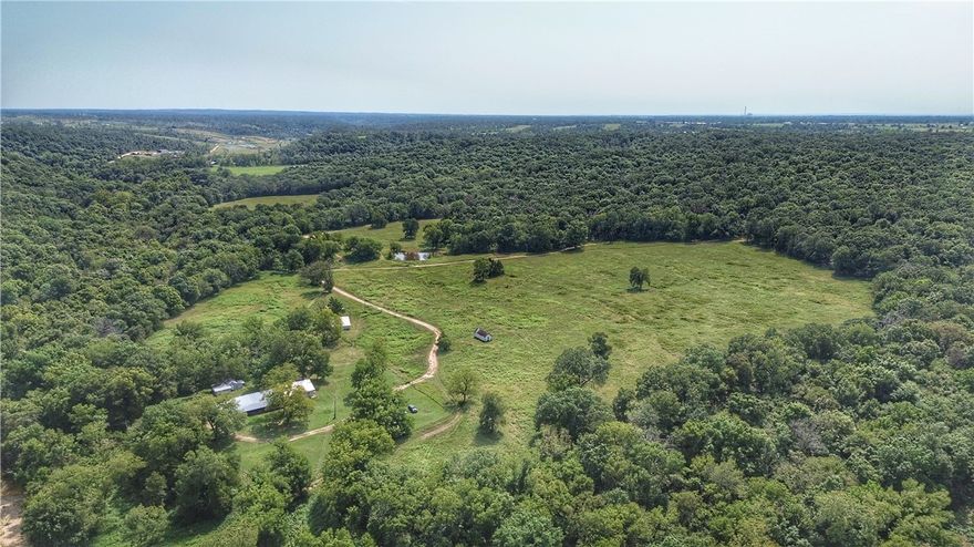 Welcome to the Allen Family Farm – a one-of-a-kind legacy property with a rich 100+ year history. This remarkable Northwest Arkansas farm for sale features rolling pastureland, mature hardwoods, and abundant natural water sources, making it a dream property for ranching, hunting, recreation, or establishing your own private estate.
The highlight of this farm is the spring-fed Coon Creek, which winds through the property and provides year-round live water while enhancing the land’s natural beauty and character. Multiple natural springs bubble up across the acreage, adding to its value and uniqueness, while a pond offers an additional reliable water source for livestock or horses.
Beyond the water, the property offers elevation changes with ridge-top views and several prime building sites overlooking the countryside. Established trails meander through the land, ideal for horseback riding, hiking, or mountain biking, making this farm jus as much a recreational paradise. 
Sale is subject to court approval.