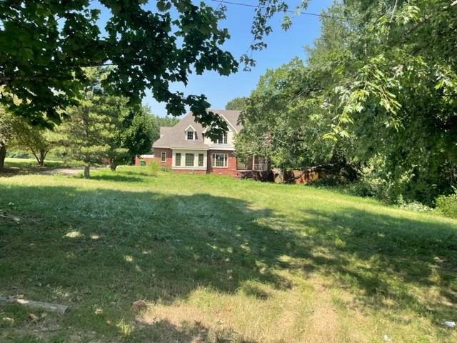 This home sits on over 2 beautiful acres with a wet weather creek and tons of beautiful mature trees providing ample privacy. Bring this beautiful tudor style home back to its glory with all your personal touches! This plan comes straight from Southern Living "Rosehaven" and offers a vaulted ceiling, fireplace flanked by bookshelves, Kitchen and light filled breakfast area that offers nice built ins and impressive butler's pantry. Master suite in seperate wing features a sitting area and private bath. A loft provides a study area or play space. Upstairs bedrooms offer private bath in 1 bedroom and jack and jill in other 2 rooms. All cash offers must be presented with proof of funds. If you choose to use the Sellers preferred title insurance provider, the seller will pay for the buyers owner title policy. Will not accept conventional loans. Seller will only accept cash or rehab loans.