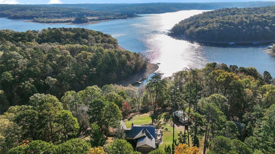 Welcome to your idyllic lakeside escape surrounded by natural beauty. Located right on Beaver Lake with lakefront and its own private dock! The mother-in-law suite would be a great getaway location for guests or as an airbnb- 2 beds, 1 bath! The large newly installed windows face the lake so you can enjoy views in every season. With 5 acres you can feel secluded while also being just 15 minutes away from Rogers downtown. This four bed 2.5 bath house is the perfect getaway for those that want the seclusion and peacefulness of the lake front with the amenities of city living!
