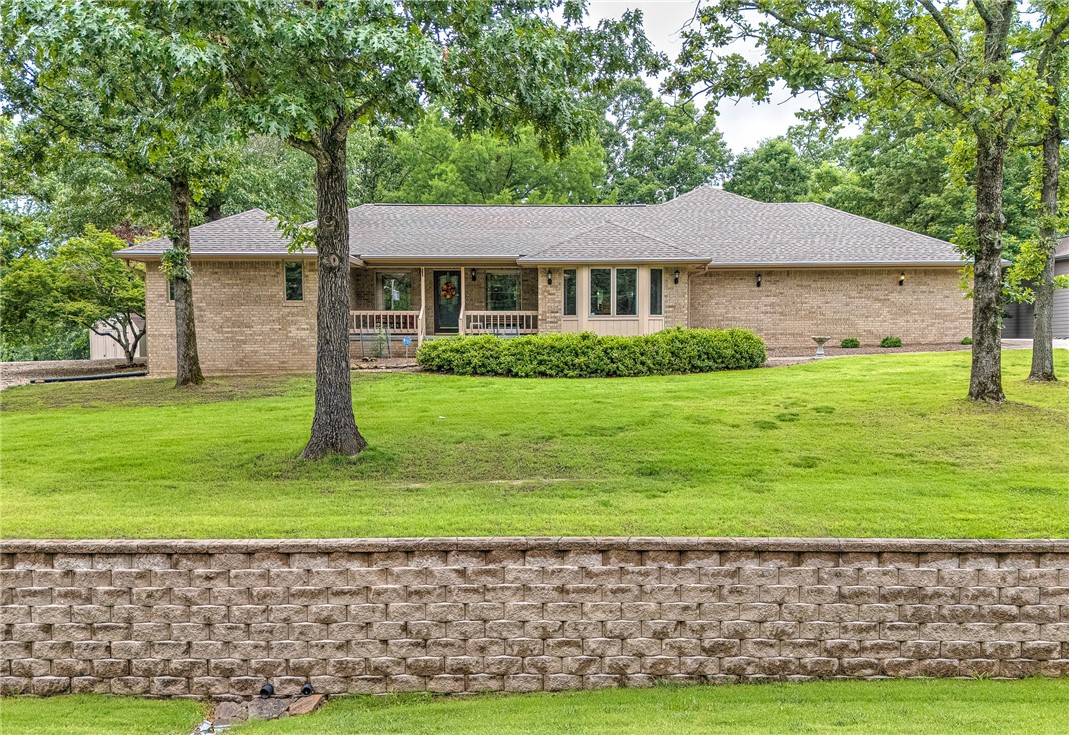 Exquisite country living within 5 minutes of beautiful historic downtown Rogers, AR. Home is situated on a wooded, landscaped ¾ acre lot surrounded by other like homes. 2 relaxing covered decks to enjoy the well-manicured backyard. The deck off the main bedroom is screened. Located within minutes of Beaver Lake for boating, fishing, camping and skiing. Also, within minutes of Hobbs State Park for hiking, horseback riding and just enjoying the outdoors. The purchase price includes an additional ¾ acre lot directly across the street to protect your view. Roof and HVAC replaced in 2021, water heater replaced in 2022. 868 sq. ft. shop is set up for woodworking. Tools and equipment do not convey. The shop has a heat pump, sink with water, upper level for storage, basement level to store your lawn equipment and can also be used as a storm shelter. The shop has staggered studs for additional insulation and sound proofing. This home is calling for you and your family. Schedule an appointment to see before it’s too late.